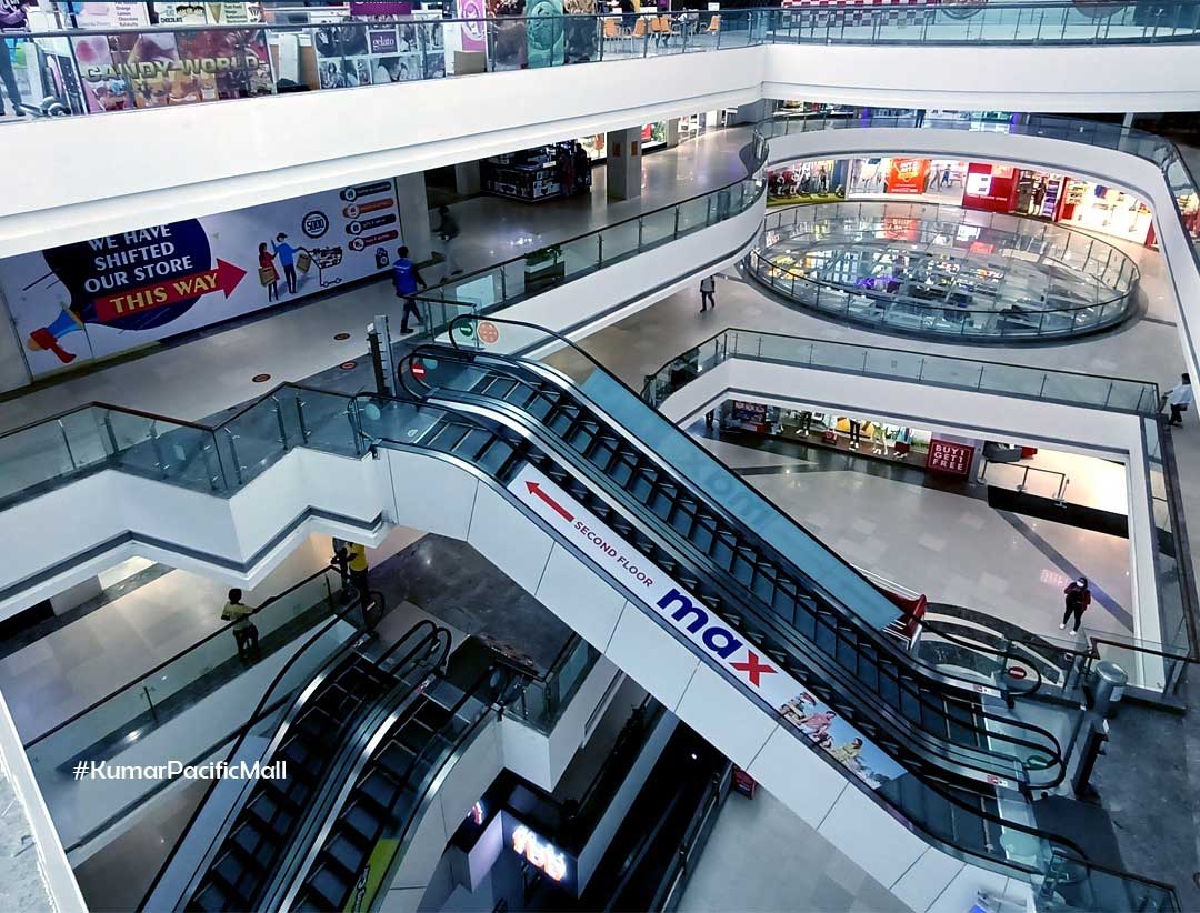 View of escalator at Kumar Pacific Mall by Kumar Realty